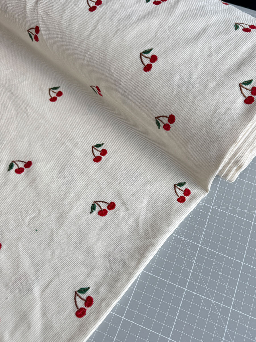 Cherry embroidered needlecord - per half metre